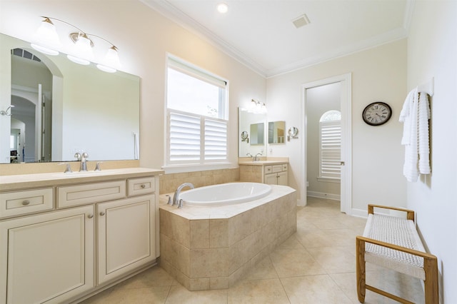 bathroom with tile patterned flooring, vanity, ornamental molding, and tiled tub