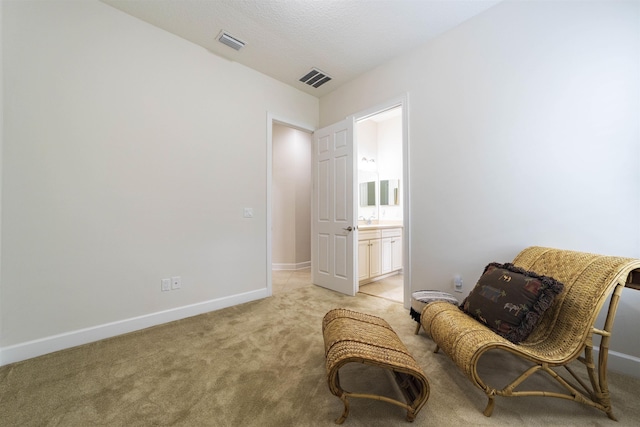 living area featuring light carpet