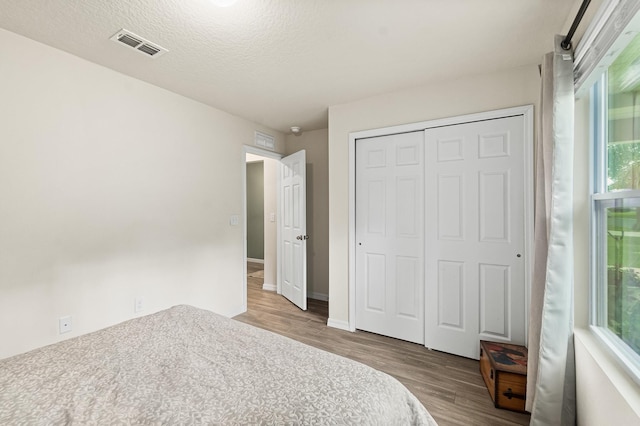 7503 Caravaca Ct, Jacksonville, FL 32244 - unfurnished bedroom featuring wood finished floors, multiple windows, and a closet