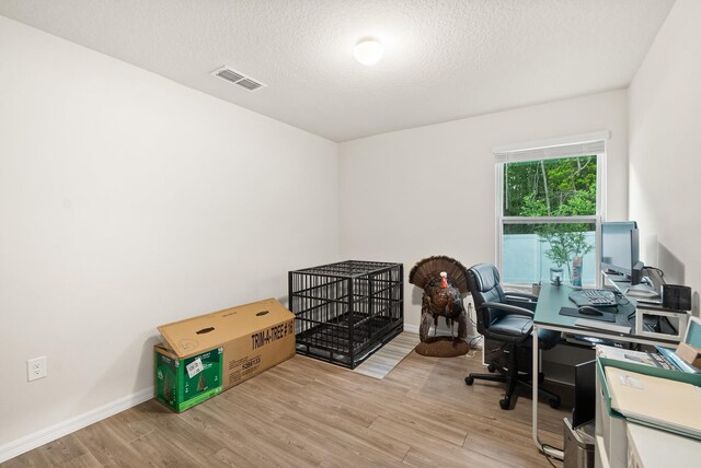 7503 Caravaca Ct, Jacksonville, FL 32244 - office area with wood finished floors, a textured ceiling, and baseboards