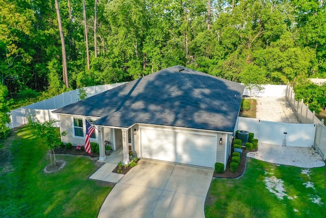 7503 Caravaca Ct, Jacksonville, FL 32244 - view of front facade with a gate, a garage, concrete driveway, a shingled roof, and a forest view