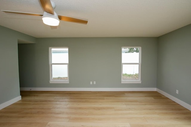 spare room featuring ceiling fan and light hardwood / wood-style flooring