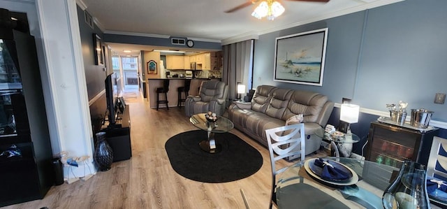 2 Dondanville Rd Unit 216, Saint Augustine Beach, FL 32080 - living area with crown molding, light wood finished floors, and a ceiling fan