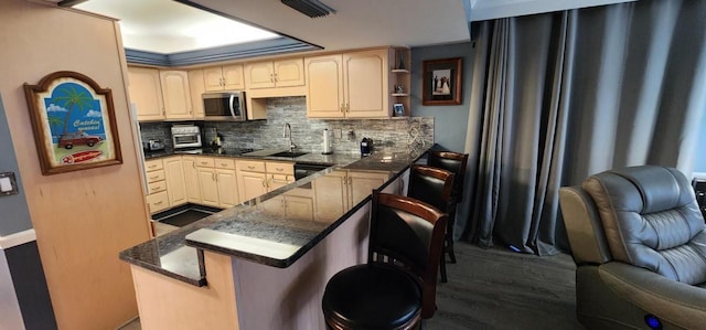 2 Dondanville Rd Unit 216, Saint Augustine Beach, FL 32080 - kitchen featuring stainless steel microwave, open floor plan, a peninsula, backsplash, and dark wood-style floors