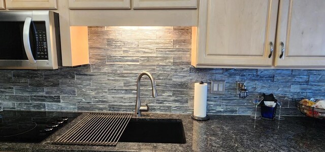 2 Dondanville Rd Unit 216, Saint Augustine Beach, FL 32080 - kitchen with stainless steel microwave, tasteful backsplash, and dark stone counters