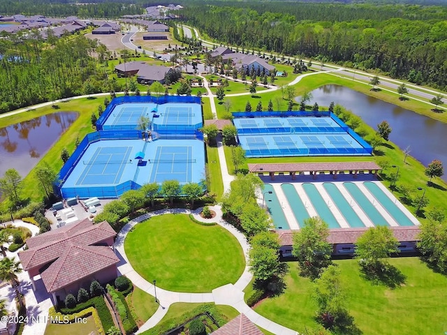 aerial view featuring a wooded view and a water view