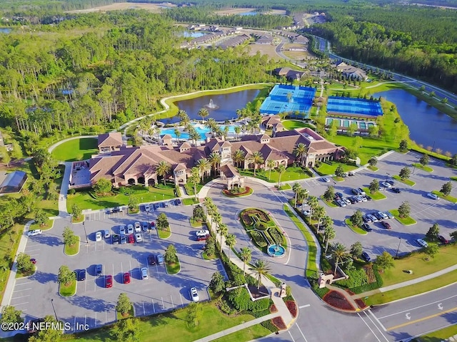 birds eye view of property featuring a water view and a view of trees