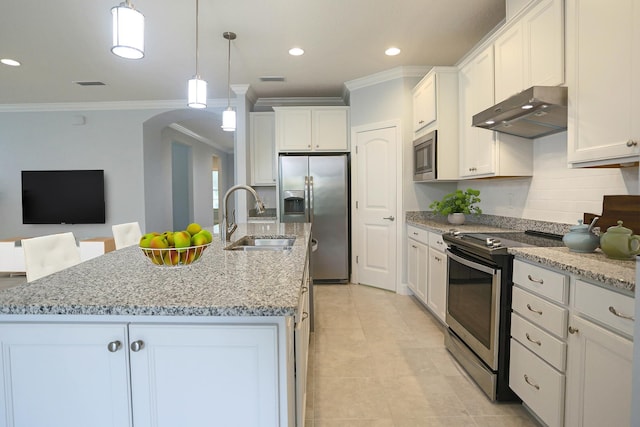 kitchen with a sink, under cabinet range hood, ornamental molding, arched walkways, and appliances with stainless steel finishes