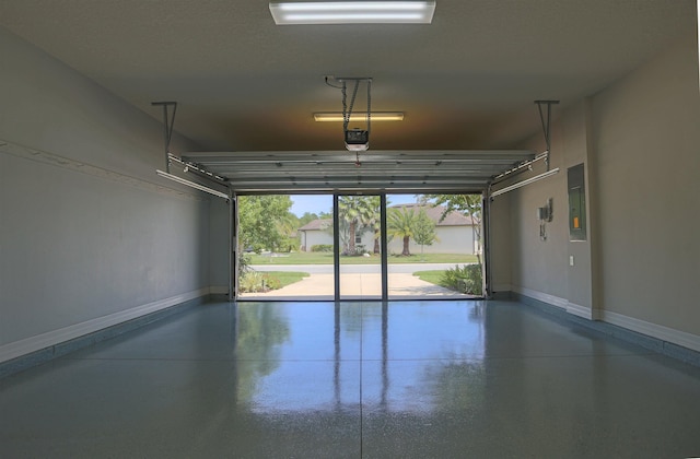garage with a garage door opener, electric panel, and baseboards