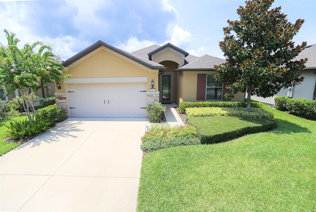 ranch-style house with driveway, stone siding, an attached garage, stucco siding, and a front lawn