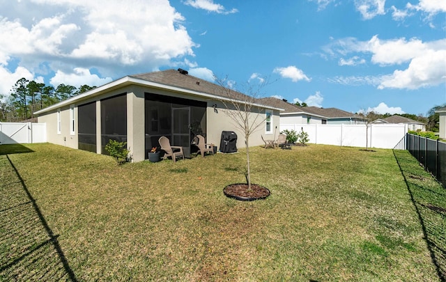 59 Oakleaf Way, Palm Coast, FL 32137 - rear view of house featuring a yard, stucco siding, a sunroom, and a fenced backyard