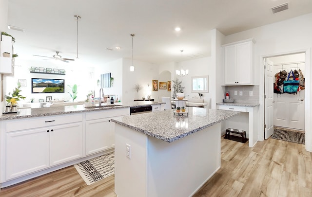 59 Oakleaf Way, Palm Coast, FL 32137 - kitchen with a sink, light wood finished floors, a center island, and visible vents