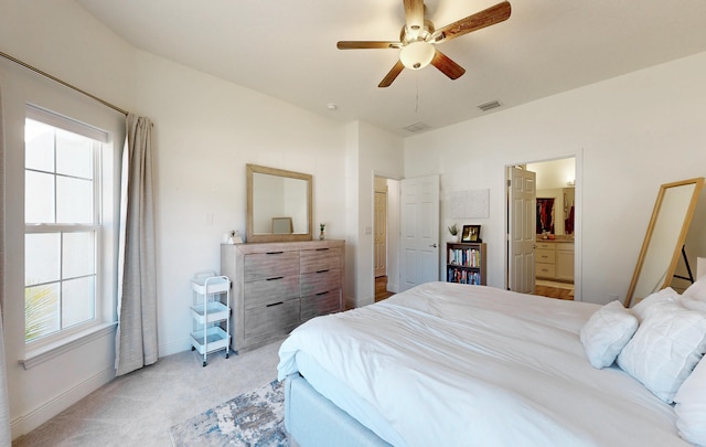 59 Oakleaf Way, Palm Coast, FL 32137 - bedroom with a ceiling fan, ensuite bathroom, baseboards, visible vents, and light carpet