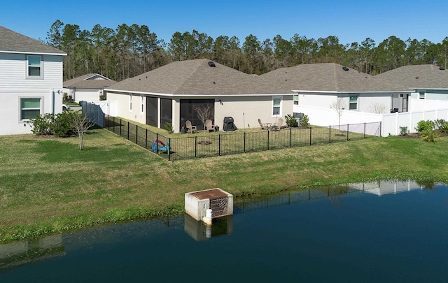 59 Oakleaf Way, Palm Coast, FL 32137 - back of house featuring a lawn, a water view, and fence