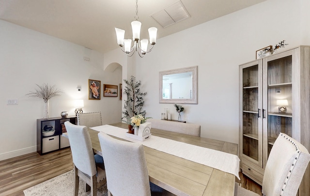 59 Oakleaf Way, Palm Coast, FL 32137 - dining area featuring visible vents, wood finished floors, baseboards, and a notable chandelier