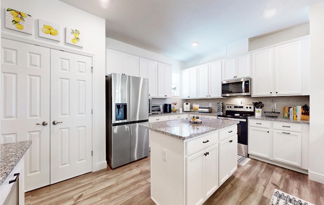 59 Oakleaf Way, Palm Coast, FL 32137 - kitchen with light wood-style flooring, appliances with stainless steel finishes, and tasteful backsplash