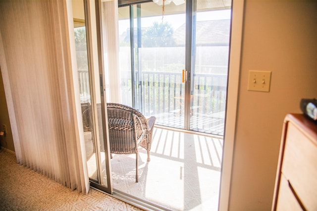 doorway to outside featuring carpet flooring