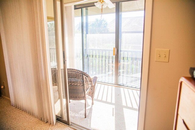 entryway featuring ceiling fan and carpet floors