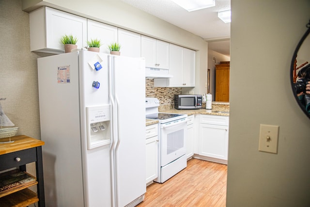 kitchen with white cabinets, light hardwood / wood-style floors, white appliances, and tasteful backsplash