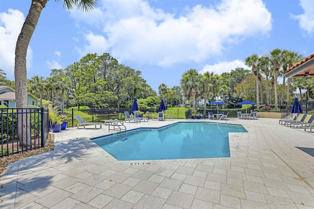 1 Sandpiper Cv, Ponte Vedra Beach, FL 32082 - community pool featuring a patio area and view of scattered trees