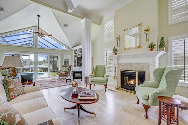 1 Sandpiper Cv, Ponte Vedra Beach, FL 32082 - living area featuring a fireplace, a water view, ceiling fan, high vaulted ceiling, and decorative columns
