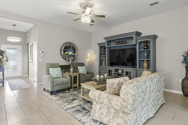 living room featuring a textured ceiling and ceiling fan