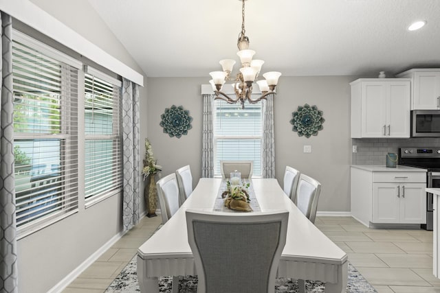 dining room featuring lofted ceiling, a notable chandelier, and a healthy amount of sunlight