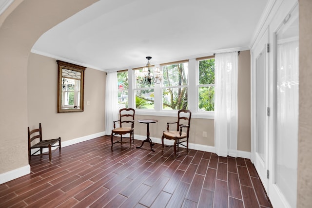 12 E Park Ave, Saint Augustine, FL 32084 - living area with dark wood finished floors, crown molding, a chandelier, and arched walkways