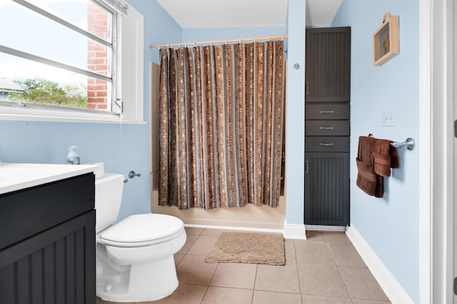 full bathroom with tile patterned floors, shower / bath combo with shower curtain, vanity, and toilet