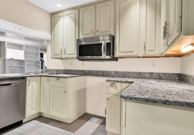 12 E Park Ave, Saint Augustine, FL 32084 - kitchen with appliances with stainless steel finishes, cream cabinetry, light tile patterned floors, and recessed lighting
