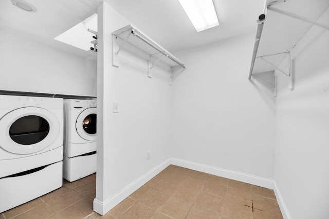 washroom with washer and dryer and light tile patterned flooring