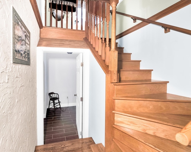 stairs featuring hardwood / wood-style flooring