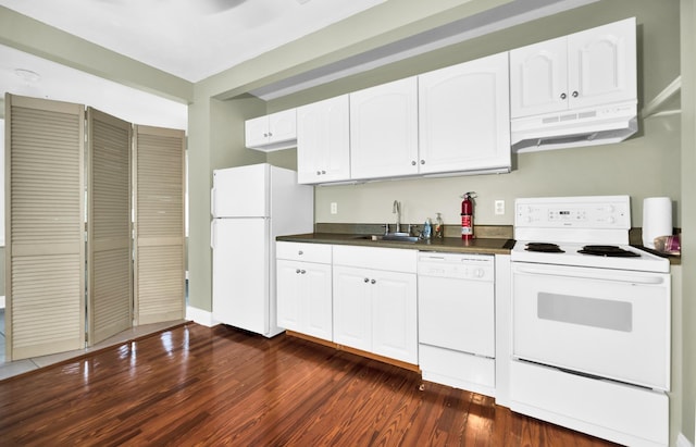 12 E Park Ave, Saint Augustine, FL 32084 - kitchen with white appliances, under cabinet range hood, dark countertops, dark wood finished floors, and white cabinets