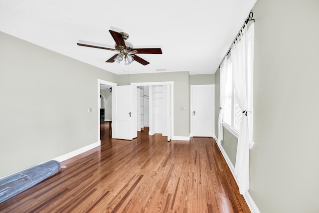 unfurnished bedroom featuring ceiling fan and hardwood / wood-style flooring