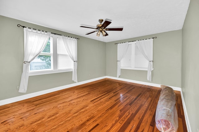 unfurnished room with ceiling fan and hardwood / wood-style flooring