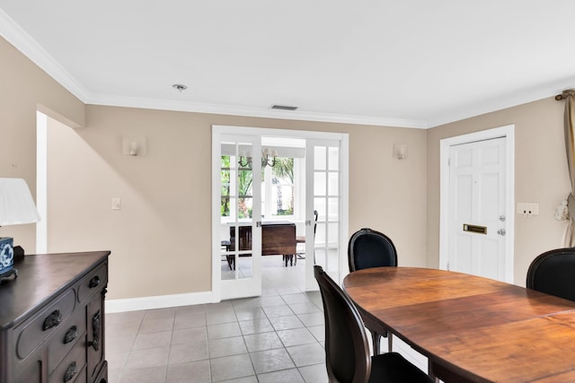 dining space featuring french doors, light tile patterned flooring, and ornamental molding