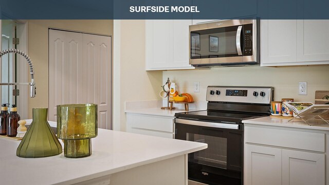 55 Rose Dr Unit B, Palm Coast, FL 32164 - kitchen featuring white cabinets and appliances with stainless steel finishes