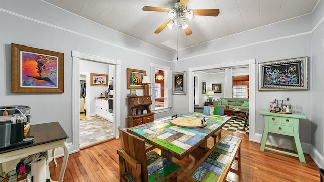 dining room with ceiling fan and light wood-type flooring