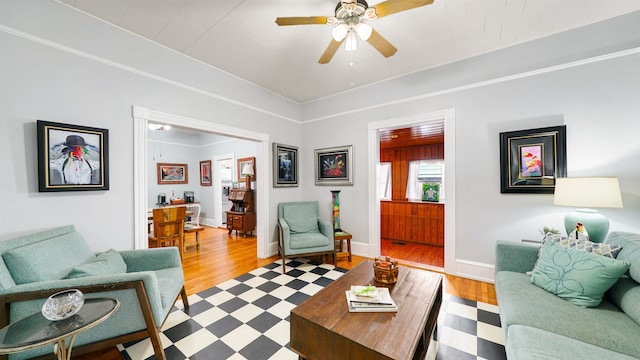 living room featuring ceiling fan and light hardwood / wood-style floors