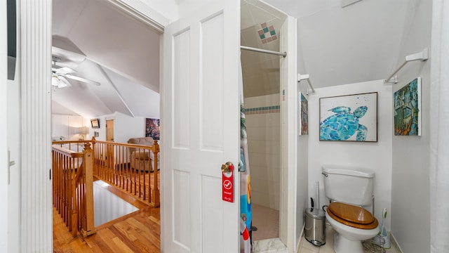 bathroom featuring curtained shower, lofted ceiling, hardwood / wood-style flooring, ceiling fan, and toilet