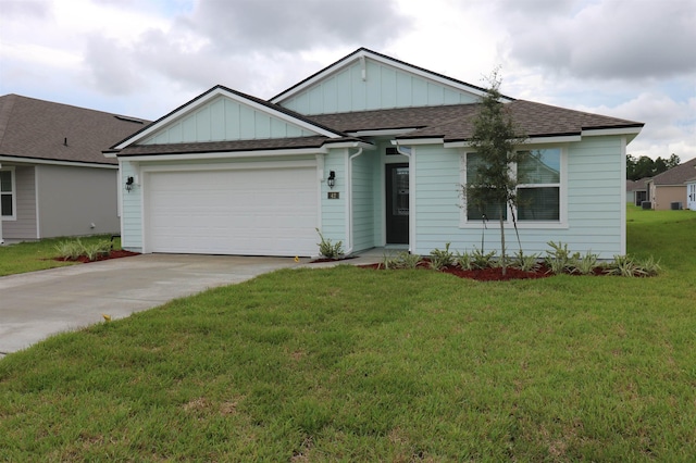 view of front of home with a garage and a front lawn