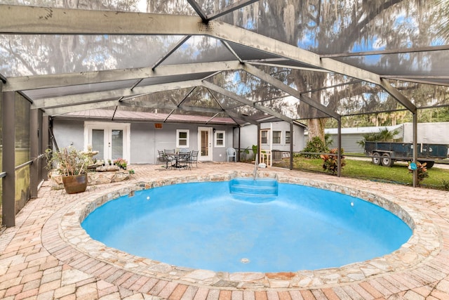 view of pool with a patio area, a lanai, and french doors