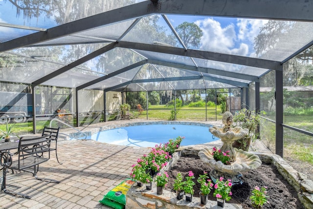 view of swimming pool featuring a lanai and a patio