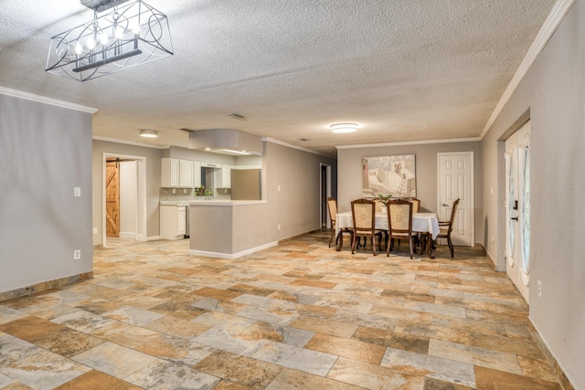 dining space featuring ornamental molding and a textured ceiling