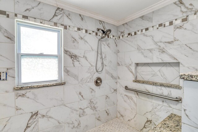 bathroom featuring tiled shower and crown molding