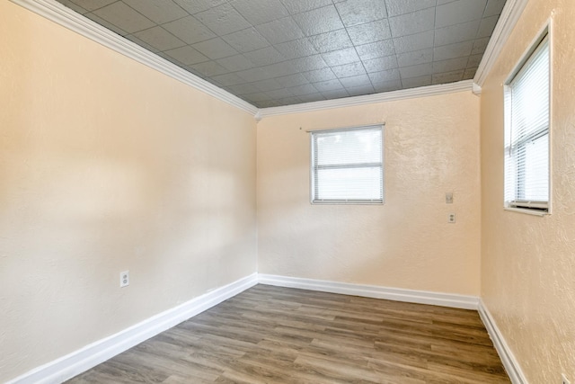 spare room with wood-type flooring and ornamental molding