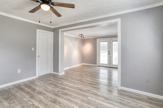 spare room with ceiling fan, light hardwood / wood-style floors, crown molding, and french doors