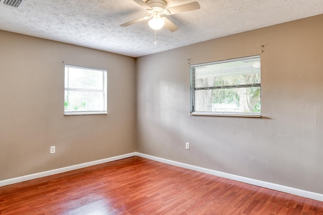 spare room featuring hardwood / wood-style floors, a textured ceiling, and ceiling fan