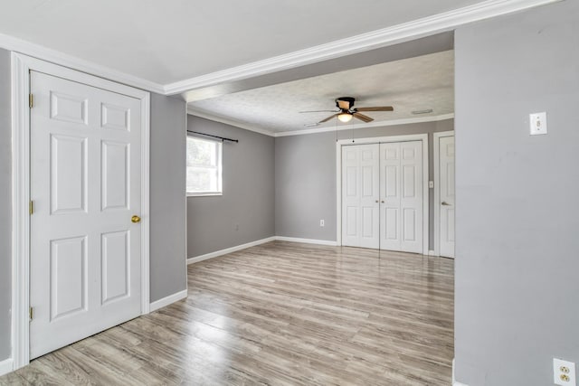 unfurnished bedroom with light hardwood / wood-style flooring, ceiling fan, and ornamental molding