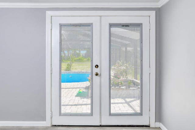 doorway featuring french doors and ornamental molding